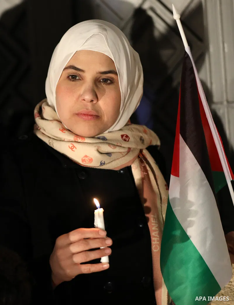 Palestinians light candles during a gathering in solidarity with the people of Turkey and Syria following a devastating earthquake, in Gaza city on Feb. 13, 2023. A 7.8-magnitude earthquake hit Turkey and Syria on Februa...