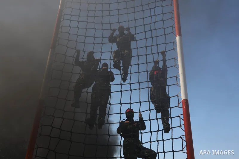 Palestinian girls from the National Resistance Brigades, the military wing of the Democratic Front for the Liberation of Palestine, participate in a military exercise on the 54th anniversary of the movement's launch, in...