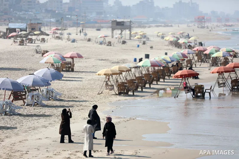 Palestinians enjoy on the sea port of Gaza City, on February 20, 2023. Weather today in Palestine is clear and warm in daytime with a further rise in temperature, and very cold conditions are expected at nighttime especi...