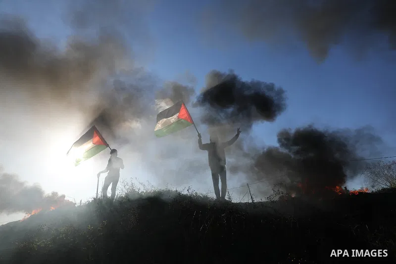 Palestinians burn tires during a protest against the killing of 10 Palestinians during an Israeli raid in Nablus near the fence with Israel east of Gaza city on Feb. 22, 2023. 10 Palestinians were killed and dozens shot...