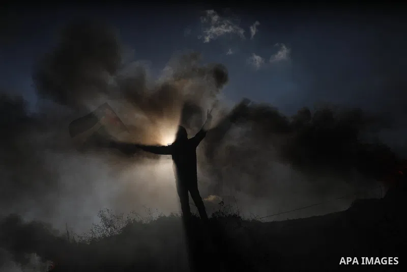 Palestinians burn tires during a protest against the killing of 10 Palestinians during an Israeli raid in Nablus near the fence with Israel east of Gaza city on Feb. 22, 2023. 10 Palestinians were killed and dozens shot...