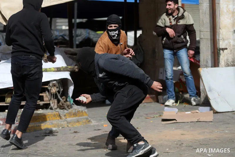 Palestinian protesters clash with Israeli forces following a protest against the presence of Israeli settlers in Hebron and to commemorate the 1994 Ibrahimi Mosque massacre, in the centre of the West Bank town on Feb. 24...