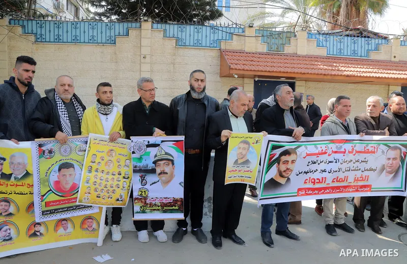 Palestinians take part in a protest in solidarity with prisoners in Israeli jails, in front of the headquarters of the World Health Organization in Gaza City on 26 February 2023. Palestinian freedom fighters incarcerated...