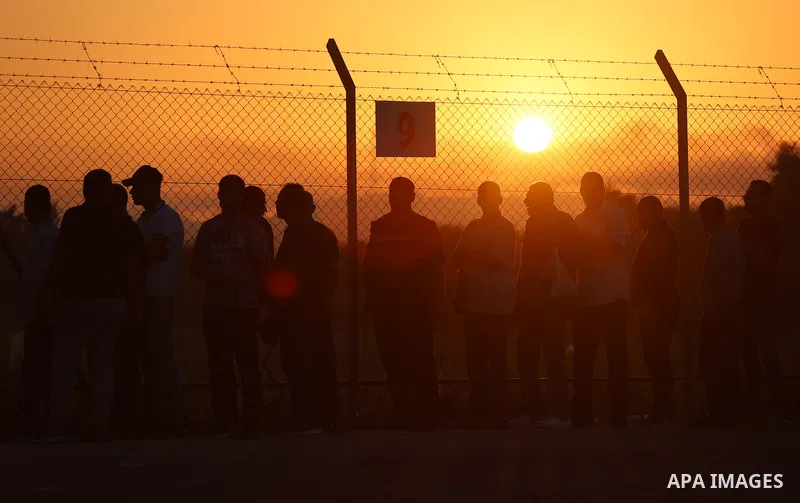 Palestinian workers wait at the Erez crossing as they prepare to leave Beit Hanun in the northern Gaza Strip, to go to work inside Israel, on September 28, 2023. Erez Crossing opened after closing it two weeks ago in res...