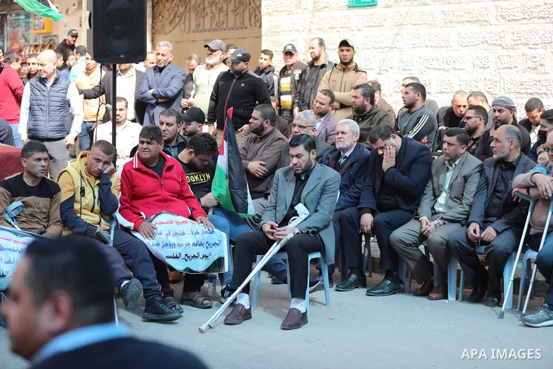 Palestinians take part in a protest in solidarity with prisoners in Israeli jails, on the Palestinian Wounded's Day, in front of Red cross office, in Gaza city on March 13, 2023. Photo by Atia Darwish