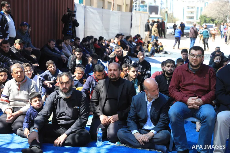 Palestinians attend Friday prayer in front of Red Cross office to support prisoners in Israeli jails, in Gaza city on March 17, 2023. Thousands of Palestinian political prisoners in Israeli prisons continue their civil d...