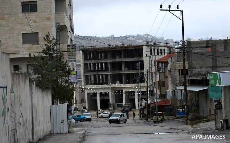 Israeli soldiers gather at a checkpoint at the entrance of the Palestinian town of Huwara, in the occupied West Bank, following a reported shooting attack on an Israeli car, on March 19, 2023. The shooting attack in the...