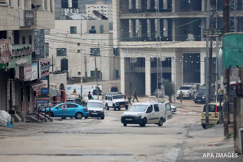 Israeli soldiers gather at a checkpoint at the entrance of the Palestinian town of Huwara, in the occupied West Bank, following a reported shooting attack on an Israeli car, on March 19, 2023. The shooting attack in the...