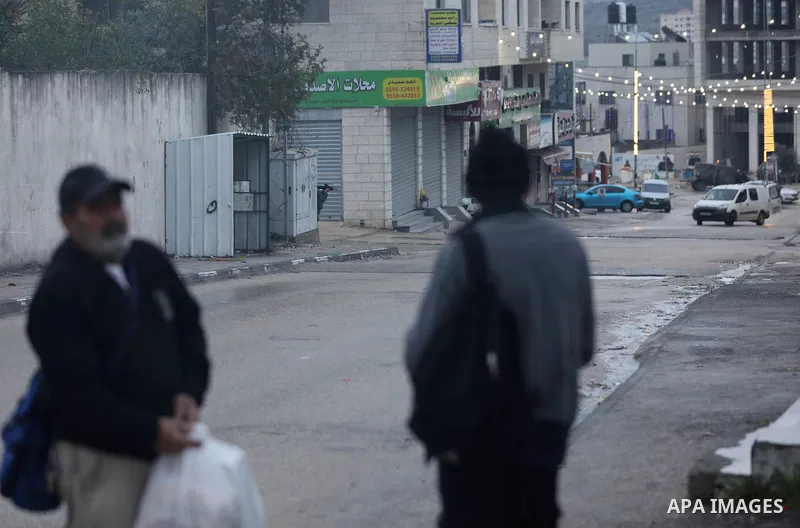Israeli soldiers gather at a checkpoint at the entrance of the Palestinian town of Huwara, in the occupied West Bank, following a reported shooting attack on an Israeli car, on March 19, 2023. The shooting attack in the...