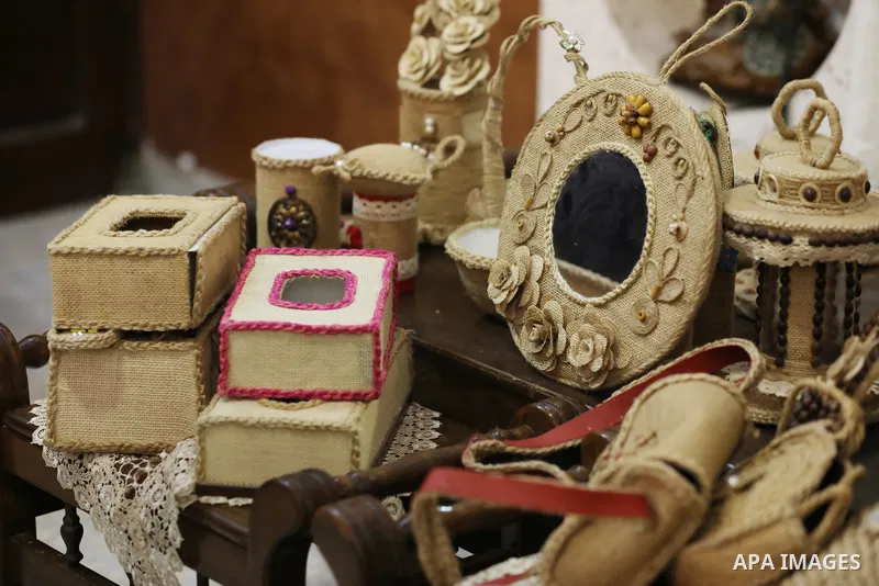 Palestinian woman, Raghda Abu Assi makes handicrafts from burlap at her home in Gaza city on August 14, 2023. A family project in which all family members have been working for more than 27 years, using burlap to revive...