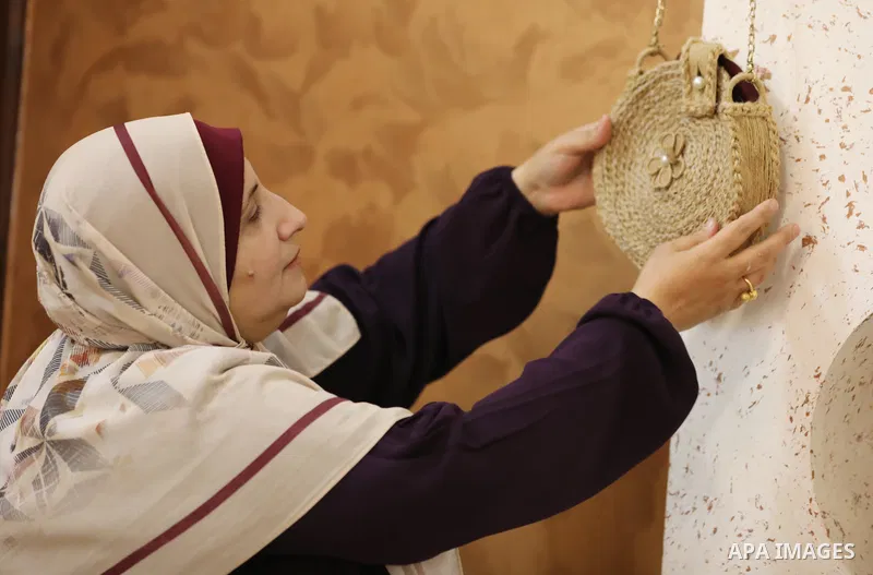 Palestinian woman, Raghda Abu Assi makes handicrafts from burlap at her home in Gaza city on August 14, 2023. A family project in which all family members have been working for more than 27 years, using burlap to revive...