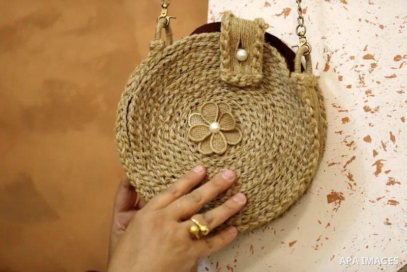 Palestinian woman, Raghda Abu Assi makes handicrafts from burlap at her home in Gaza city on August 14, 2023. A family project in which all family members have been working for more than 27 years, using burlap to revive...
