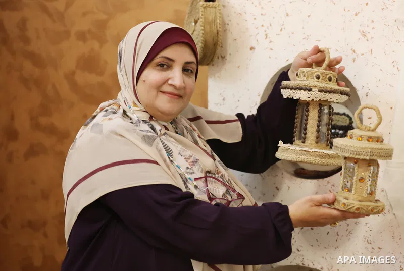 Palestinian woman, Raghda Abu Assi makes handicrafts from burlap at her home in Gaza city on August 14, 2023. A family project in which all family members have been working for more than 27 years, using burlap to revive...