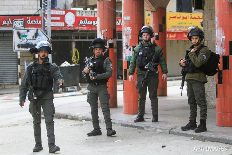 Israeli soldiers patrol Huwara in the West Bank, on March 20, 2023, a day after a shooting attack on an Israeli settler's car in the Palestinian town. Photo by Mohammed Nasser\ apaimages