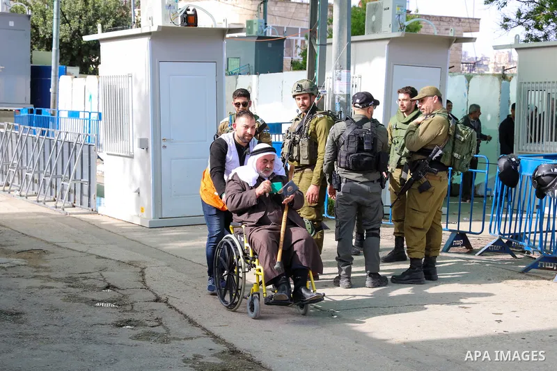 Palestinian Muslim worshippers heading to Jerusalem's Al-Aqsa Mosque compound to attend the first Friday prayer of the holy month of Ramadan, cross an Israeli held checkpoint in Bethlehem, in the West Bank on March 24, 2...
