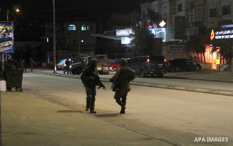 Israeli soldiers and intelligence forces inspect the site of a shooting attack on Israeli soldiers, in Hawara, south of Nablus, on 23 March 2023. Two Israeli soldiers were wounded in a shooting attack. Photo by Mohammed...
