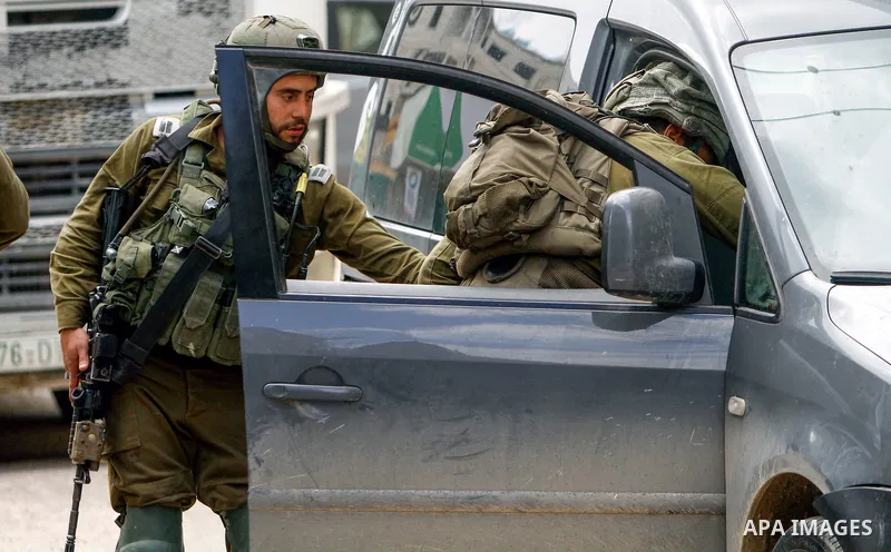 Israeli troops inspects Palestinian cars in the West Bank town of Huwara, following a shot attack on March 26, 2023. Photo by Mohammed Nasser\ apaimages