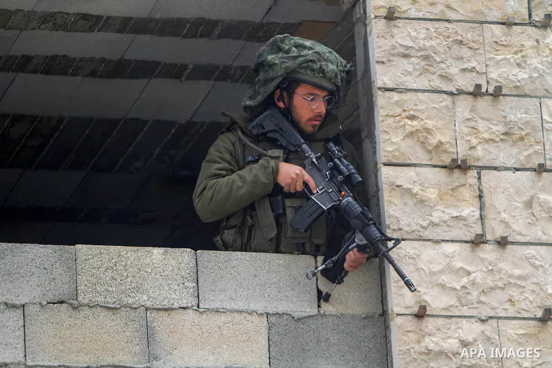 Israeli troops inspects Palestinian cars in the West Bank town of Huwara, following a shot attack on March 26, 2023. Photo by Mohammed Nasser\ apaimages