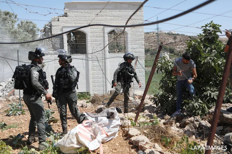 Israeli bulldozers demolish a Palestinian house built without a permit from the Israeli authorities in the area C, which lies under Israel's military control since 1967, in Hebron in the West Bank on August 29, 2023. The...