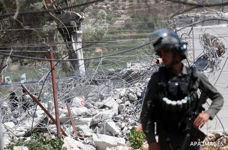 Israeli bulldozers demolish a Palestinian house built without a permit from the Israeli authorities in the area C, which lies under Israel's military control since 1967, in Hebron in the West Bank on August 29, 2023. The...