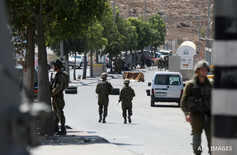 Israeli forces keep guard at the scene of what the Israeli military said is a ramming attack in the West Bank city of Hebron on August 30, 2023. Israeli forces Wednesday shot and injured a Palestinian, south of the West...