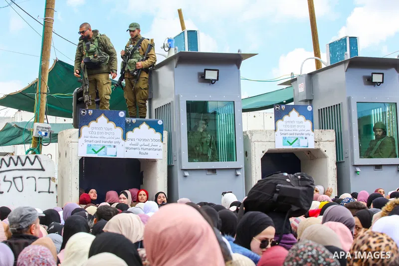 Palestinian Muslim worshippers heading to Jerusalem's Al-Aqsa Mosque compound to attend the second Friday noon prayer of the holy month of Ramadan, wait to cross an Israeli held checkpoint in Bethlehem, in the West Bank...