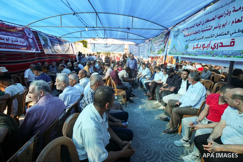 Palestinian mourners take part in the condolence tent Qadri Abu Bakr, the Chairman of the Palestine Liberation Organization (PLO)'s Detainees and Ex-Detainees Commission, who was died previous day in a tragic traffic acc...