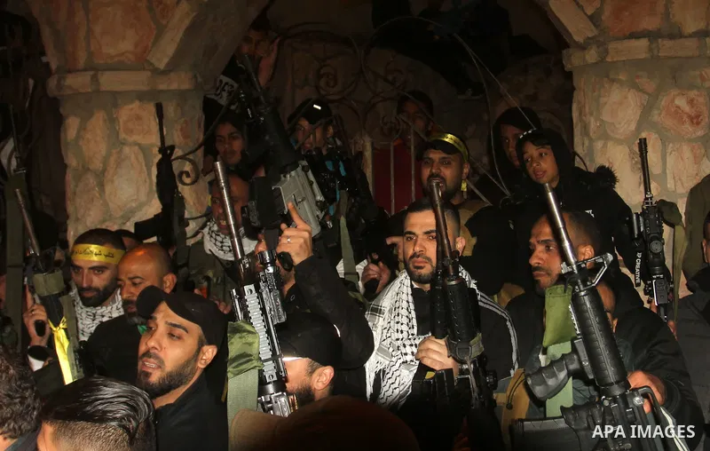 Militants from the Al-Aqsa Martyrs Brigades, the military wing of Fatah movement, celebrate following the news of an attack near the town of Beit Ummar, north of Hebron, in the West bank city of Nablus on April 1, 2023....
