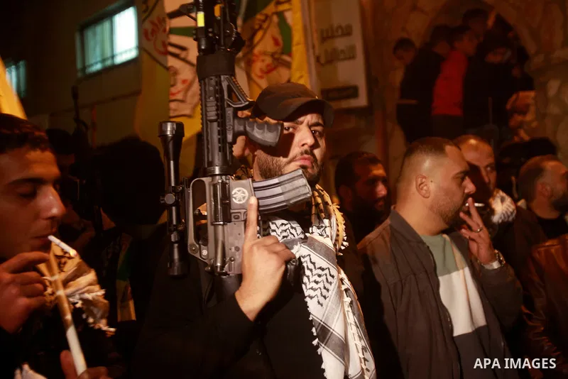 Militants from the Al-Aqsa Martyrs Brigades, the military wing of Fatah movement, celebrate following the news of an attack near the town of Beit Ummar, north of Hebron, in the West bank city of Nablus on April 1, 2023....