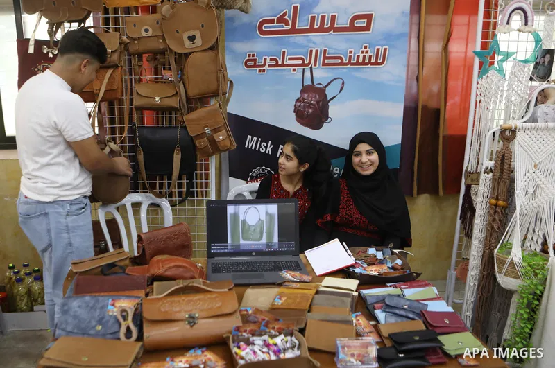 Palestinians attend an exhibition of handicrafts "Jafra Bazaar", in the West Bank city of Hebron on July 10, 2023. Photo by Mamoun Wazwaz \ apaimages