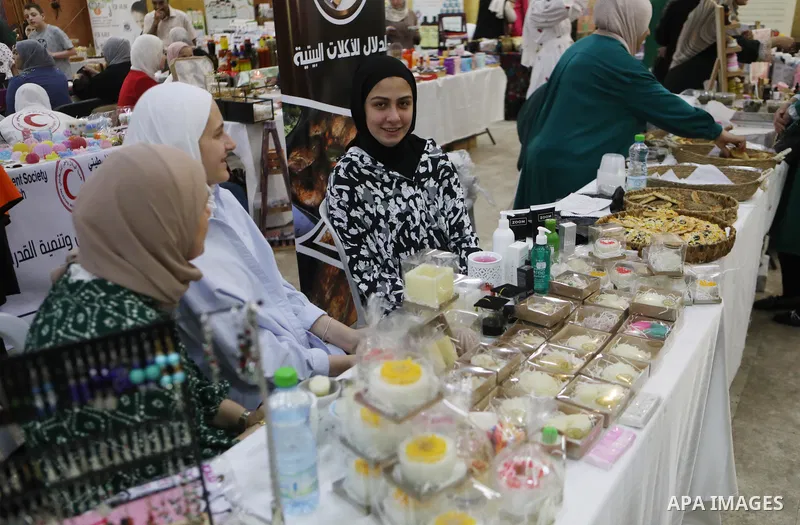 Palestinians attend an exhibition of handicrafts "Jafra Bazaar", in the West Bank city of Hebron on July 10, 2023. Photo by Mamoun Wazwaz \ apaimages