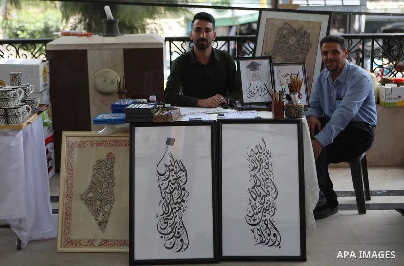 Palestinians attend an exhibition of handicrafts "Jafra Bazaar", in the West Bank city of Hebron on July 10, 2023. Photo by Mamoun Wazwaz \ apaimages