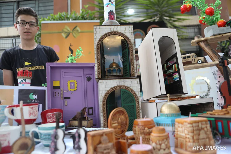 Palestinians attend an exhibition of handicrafts "Jafra Bazaar", in the West Bank city of Hebron on July 10, 2023. Photo by Mamoun Wazwaz \ apaimages