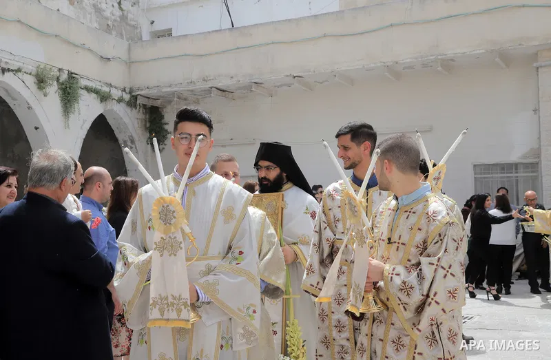 Palestinian Christians attend an Orthodox Palm Sunday, at the Church of Saint Porphyrius in Gaza city on April 09, 2023. Palm Sunday is the commemoration of the Entrance of our Lord into Jerusalem following His glorious...