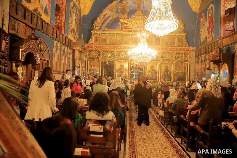 Palestinian Christians attend an Orthodox Palm Sunday, at the Church of Saint Porphyrius in Gaza city on April 09, 2023. Palm Sunday is the commemoration of the Entrance of our Lord into Jerusalem following His glorious...