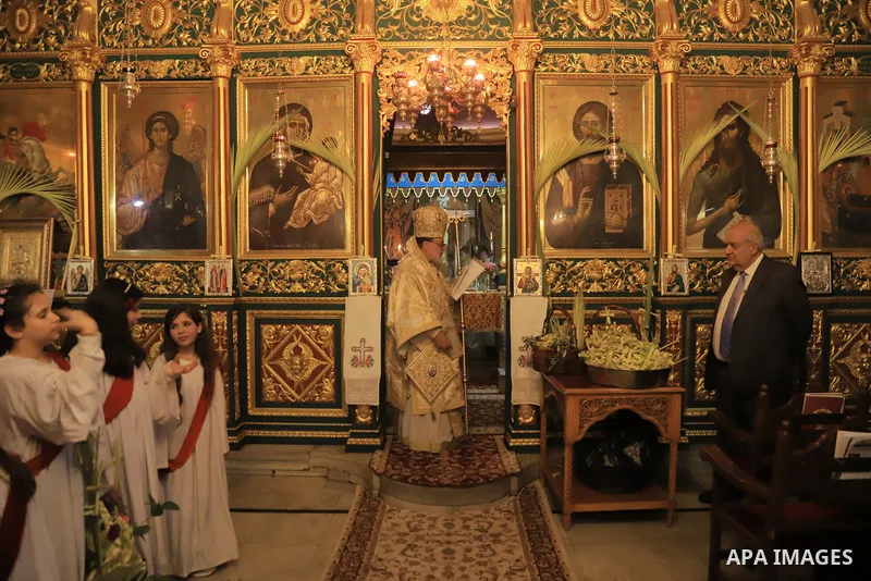 Palestinian Christians attend an Orthodox Palm Sunday, at the Church of Saint Porphyrius in Gaza city on April 09, 2023. Palm Sunday is the commemoration of the Entrance of our Lord into Jerusalem following His glorious...