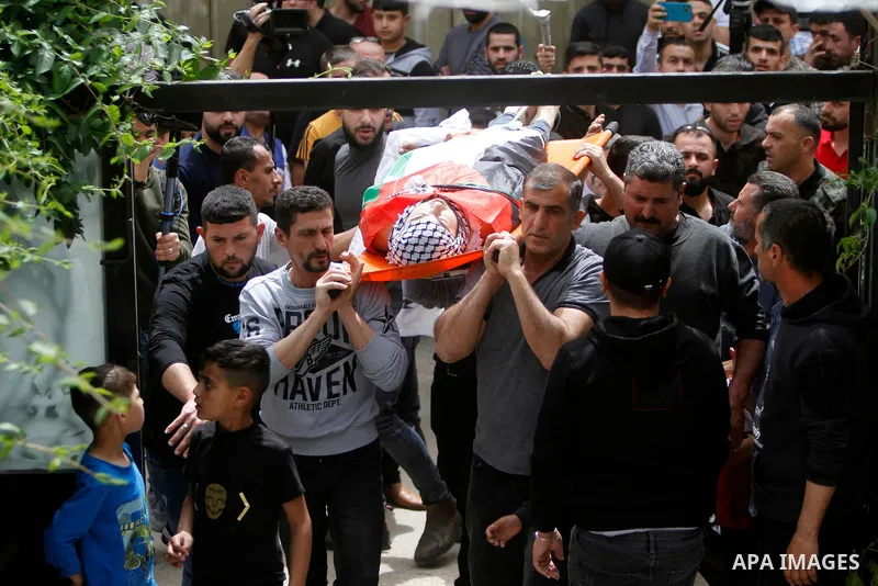 Palestinian mourners attend the funeral of Ayed Slim in his village of Azzun in the West Bank, on April 9, 2023. Israeli soldiers shot dead a Palestinian man in the north of the West Bank on April 8, the Palestinian heal...
