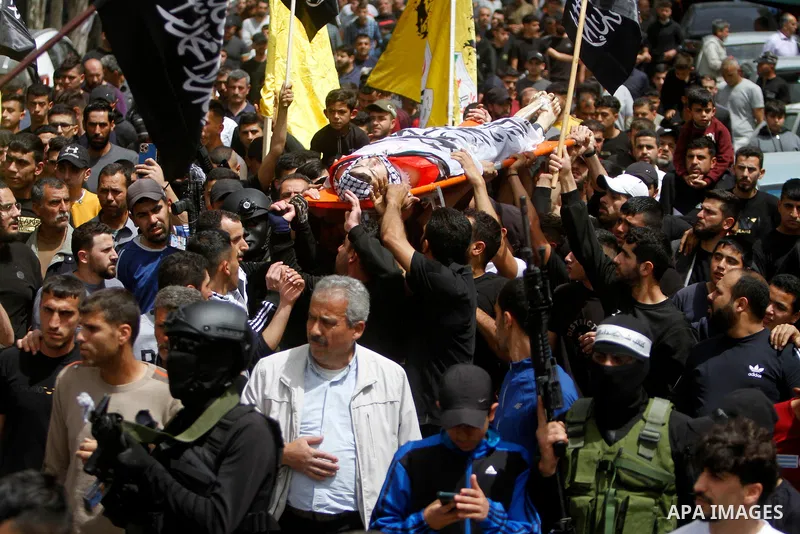 Palestinian mourners attend the funeral of Ayed Slim in his village of Azzun in the West Bank, on April 9, 2023. Israeli soldiers shot dead a Palestinian man in the north of the West Bank on April 8, the Palestinian heal...