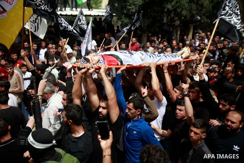 Palestinian mourners attend the funeral of Ayed Slim in his village of Azzun in the West Bank, on April 9, 2023. Israeli soldiers shot dead a Palestinian man in the north of the West Bank on April 8, the Palestinian heal...