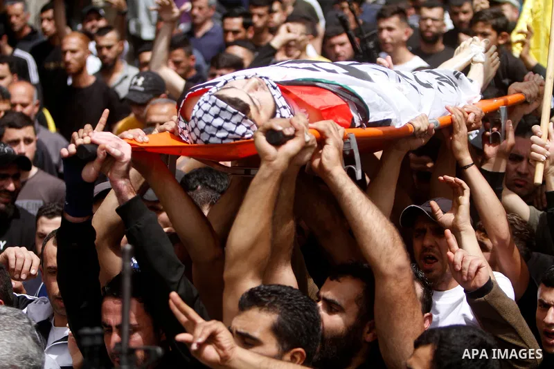 Palestinian mourners attend the funeral of Ayed Slim in his village of Azzun in the West Bank, on April 9, 2023. Israeli soldiers shot dead a Palestinian man in the north of the West Bank on April 8, the Palestinian heal...