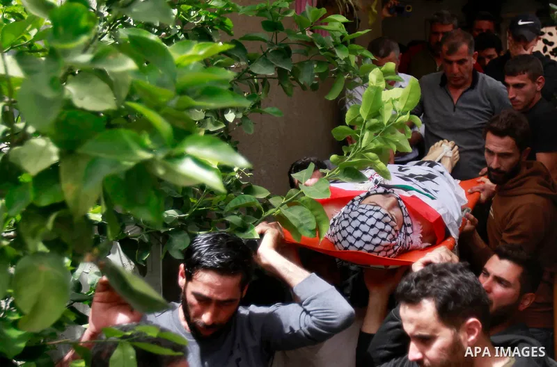 Palestinian mourners attend the funeral of Ayed Slim in his village of Azzun in the West Bank, on April 9, 2023. Israeli soldiers shot dead a Palestinian man in the north of the West Bank on April 8, the Palestinian heal...