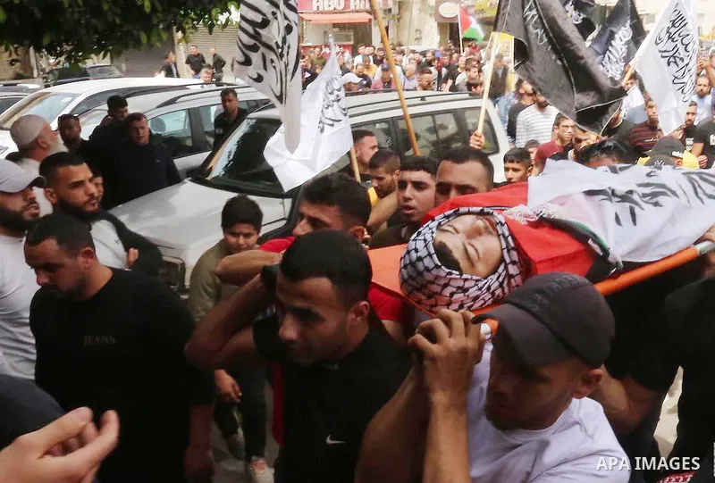 Mourners attend the funeral of Palestinian teenager Mohamed Fayez Balhan, 15, who was killed during a Israeli raid in the Aqabat Jaber camp for Palestinian refugees near Jericho in the West Bank on April 10, 2023. Photo...