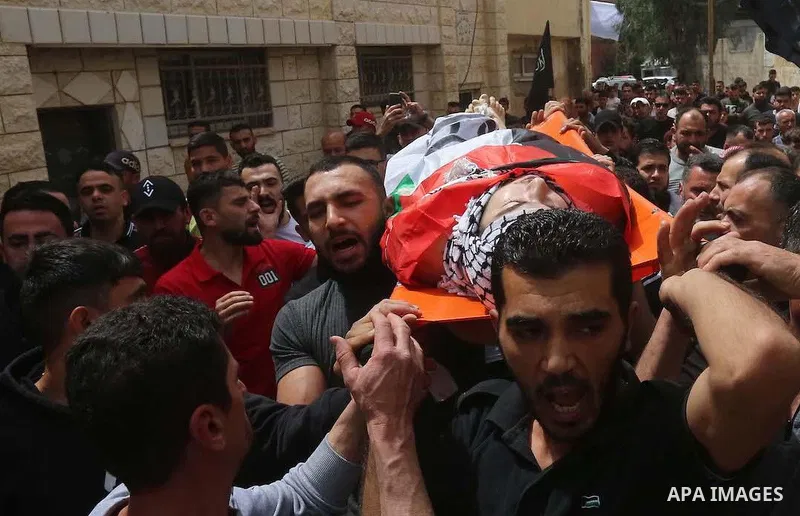 Mourners attend the funeral of Palestinian teenager Mohamed Fayez Balhan, 15, who was killed during a Israeli raid in the Aqabat Jaber camp for Palestinian refugees near Jericho in the West Bank on April 10, 2023. Photo...