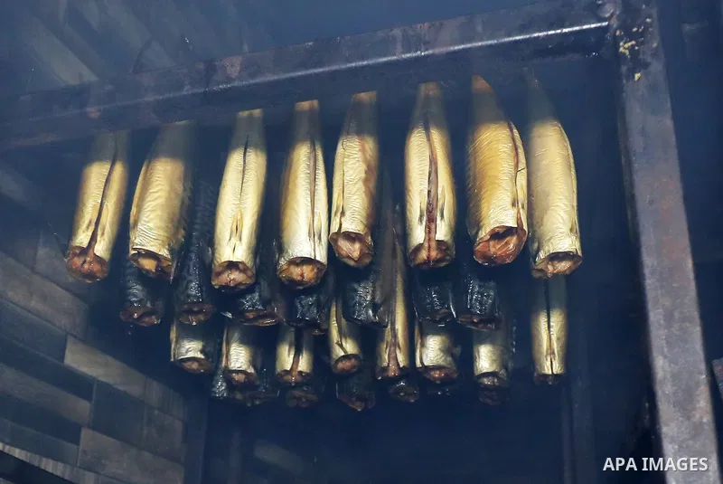 Palestinian men prepare Smoked Herring or, salted fish to be sold in markets days before of Eid al Fitr holiday at al-Maghazi refugee camp in the center of Gaza strip, on April 11, 2023. People flock markets and shopping...
