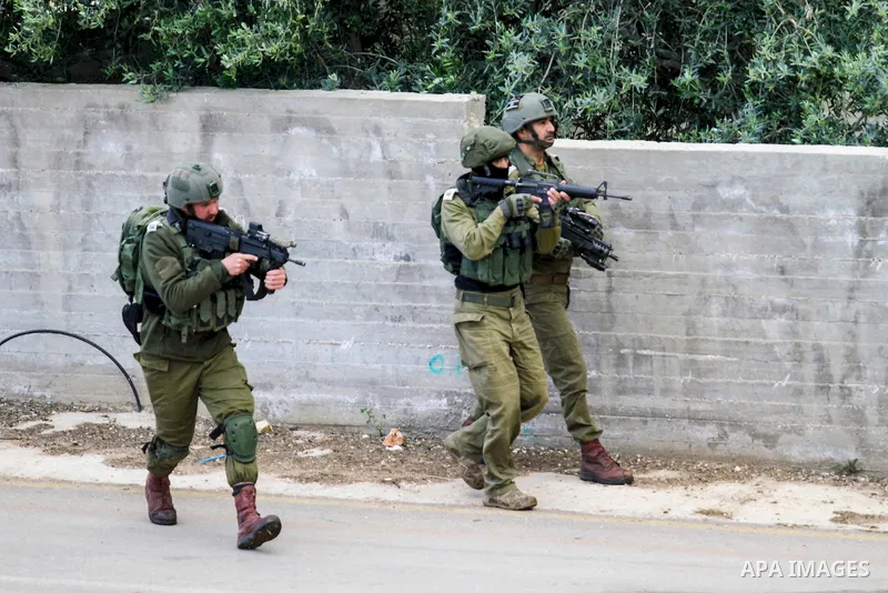 Israeli soldiers sweep an area where two Palestinians killed in clashes during an Israeli army operation, near the settlement of Elon Moreh in the West Bank near Nablus on April 11, 2023. Photo by Mohammed Nasser\ apaima...