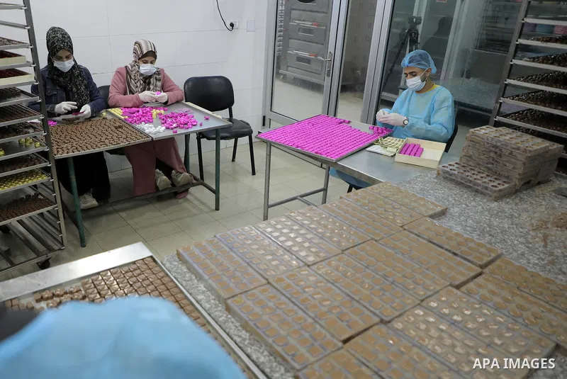 Palestinian workers prepare chocolate for the Eid al-Fitr festival at a chocolate factory in Gaza city on April 12, 2023. Eid al-Fitr is the ended of the holy month of Ramadan by praying during the night time and fasting...