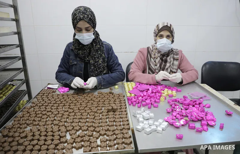 Palestinian workers prepare chocolate for the Eid al-Fitr festival at a chocolate factory in Gaza city on April 12, 2023. Eid al-Fitr is the ended of the holy month of Ramadan by praying during the night time and fasting...