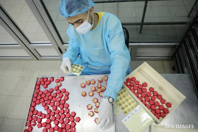 Palestinian workers prepare chocolate for the Eid al-Fitr festival at a chocolate factory in Gaza city on April 12, 2023. Eid al-Fitr is the ended of the holy month of Ramadan by praying during the night time and fasting...