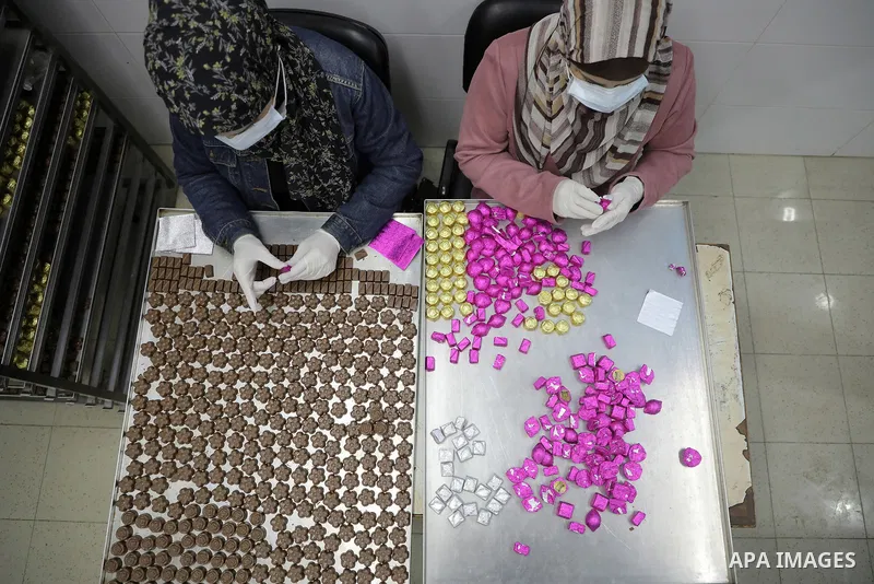 Palestinian workers prepare chocolate for the Eid al-Fitr festival at a chocolate factory in Gaza city on April 12, 2023. Eid al-Fitr is the ended of the holy month of Ramadan by praying during the night time and fasting...