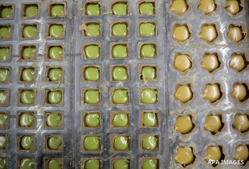 Palestinian workers prepare chocolate for the Eid al-Fitr festival at a chocolate factory in Gaza city on April 12, 2023. Eid al-Fitr is the ended of the holy month of Ramadan by praying during the night time and fasting...